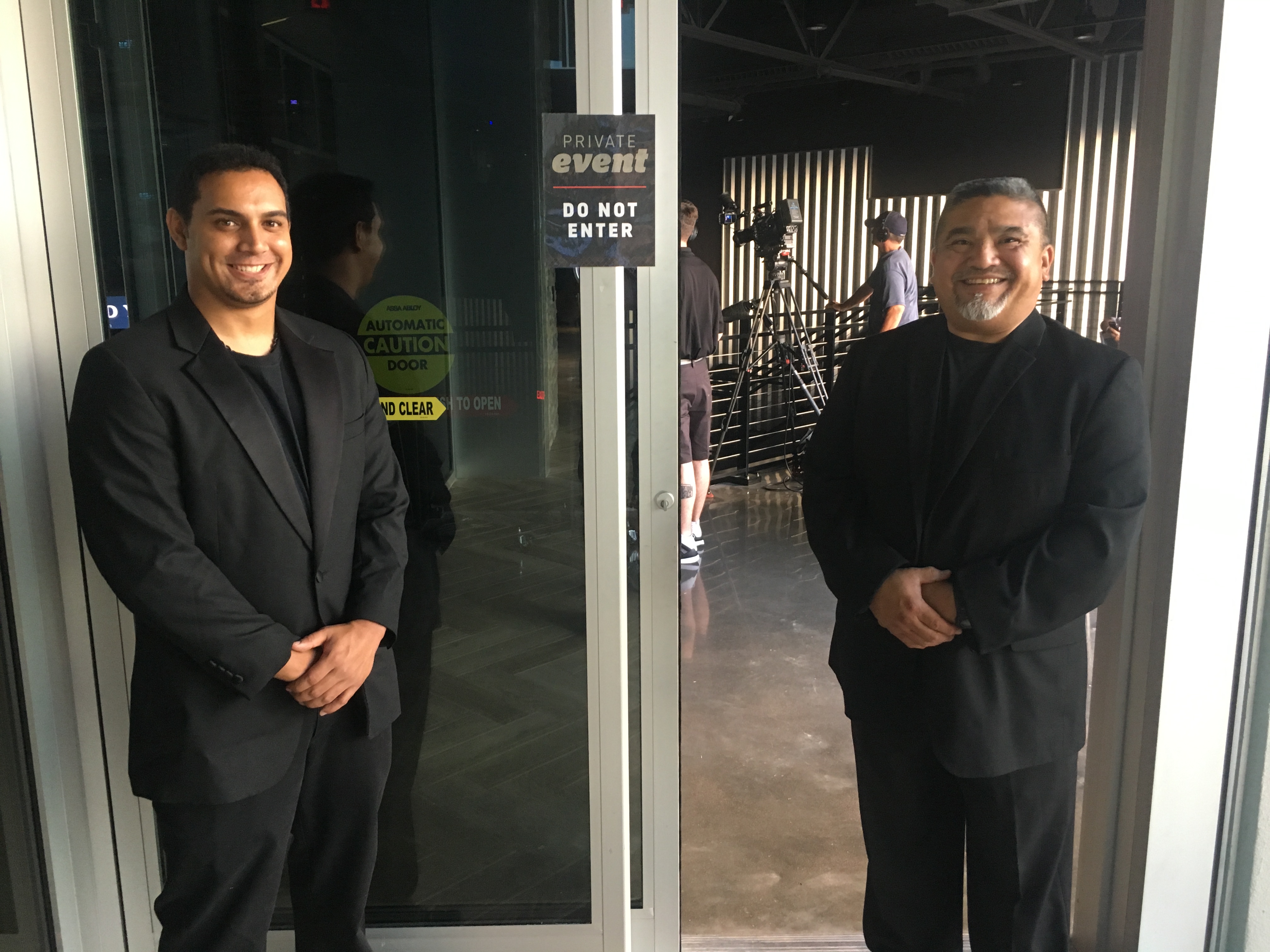 Two guards outside a private corporate event.