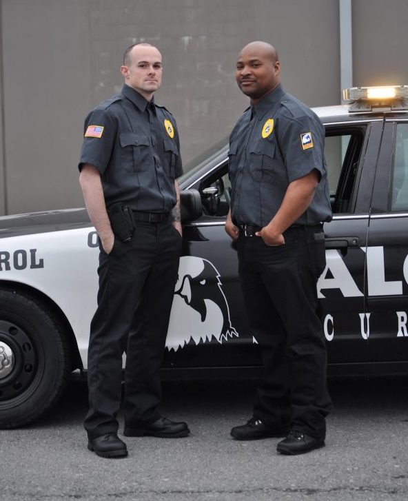 Officers standing in front of a Talon Security vehicle.